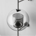 Glass wall light casting a gentle warm glow on the wall