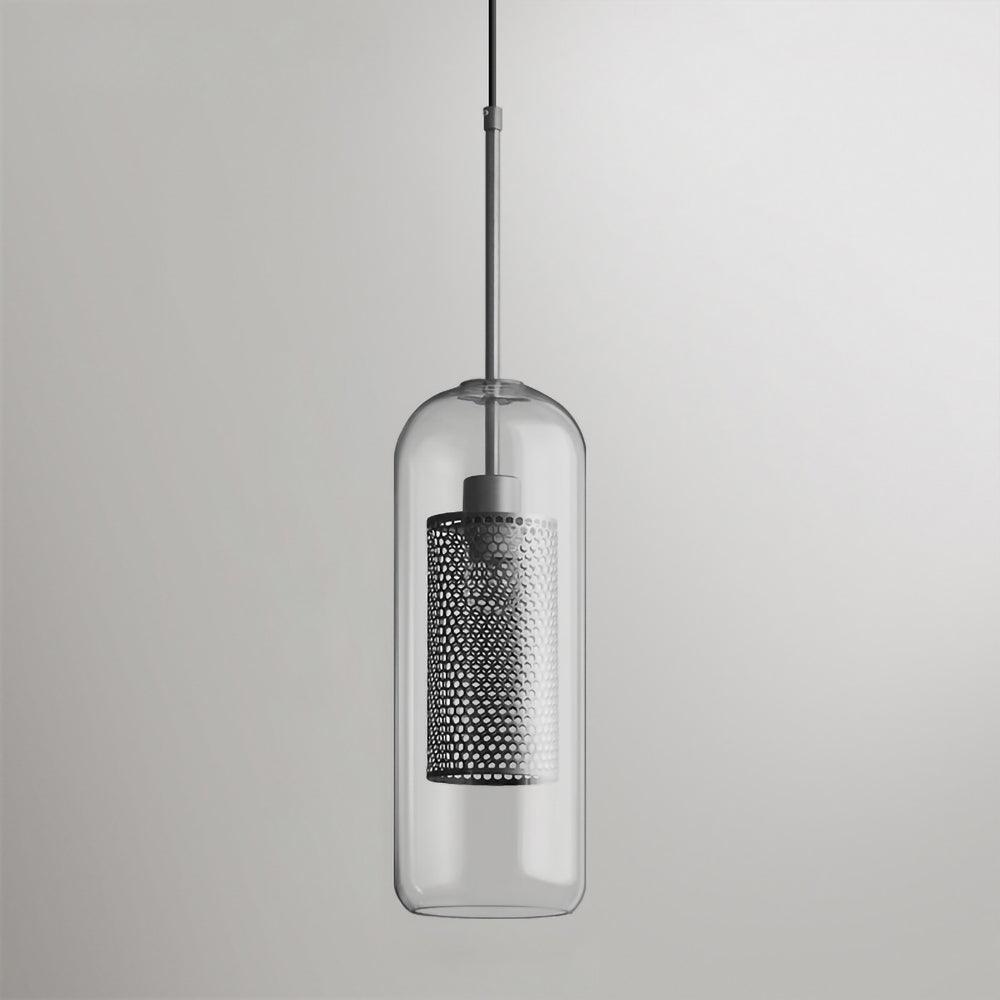 Capsule glass pendant light in silver glowing warmly over a table