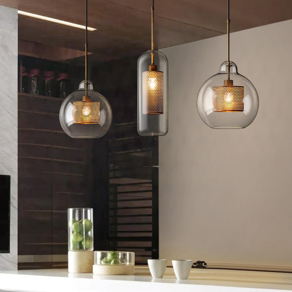 Glass pendant light cluster at staggered heights lit warmly