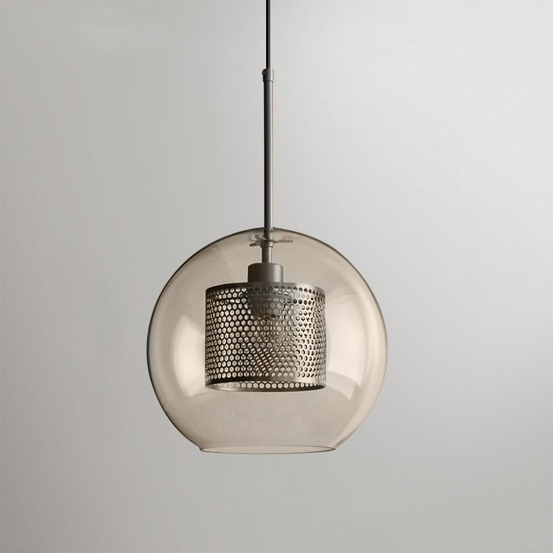 Glass pendant light cluster glowing warmly over a dining setting