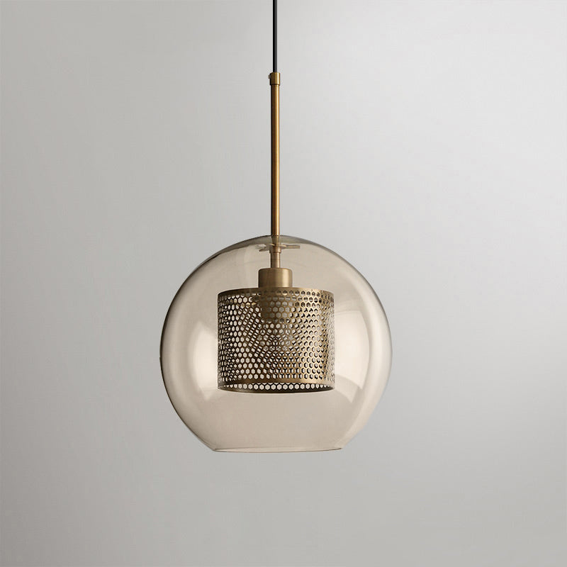 Glass pendant light glowing softly against a pale background