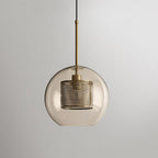 Glass pendant light glowing softly against a pale background