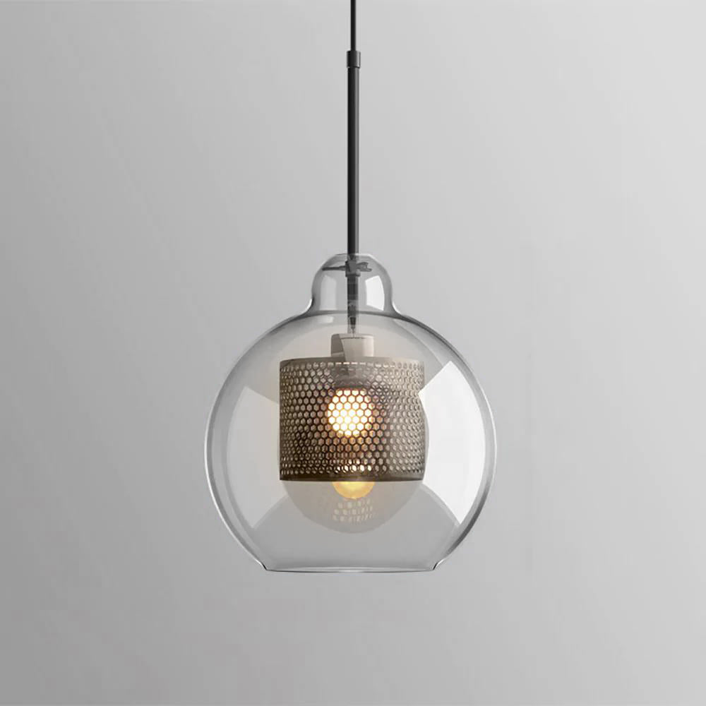 Glass pendant light with slim metal stem lit softly over a room