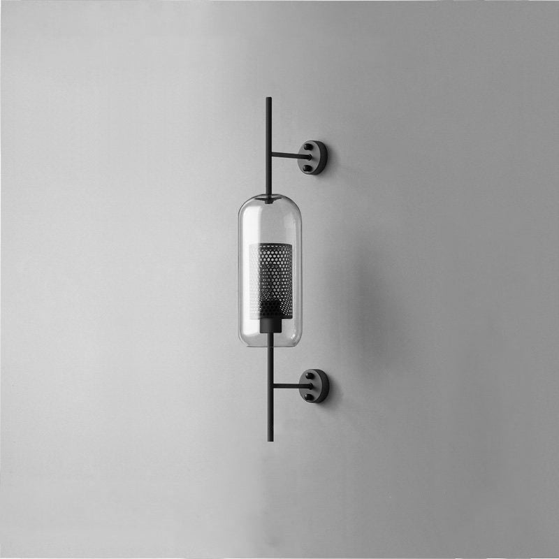 Hand-cut glass wall light with slim metal stem lit softly indoors