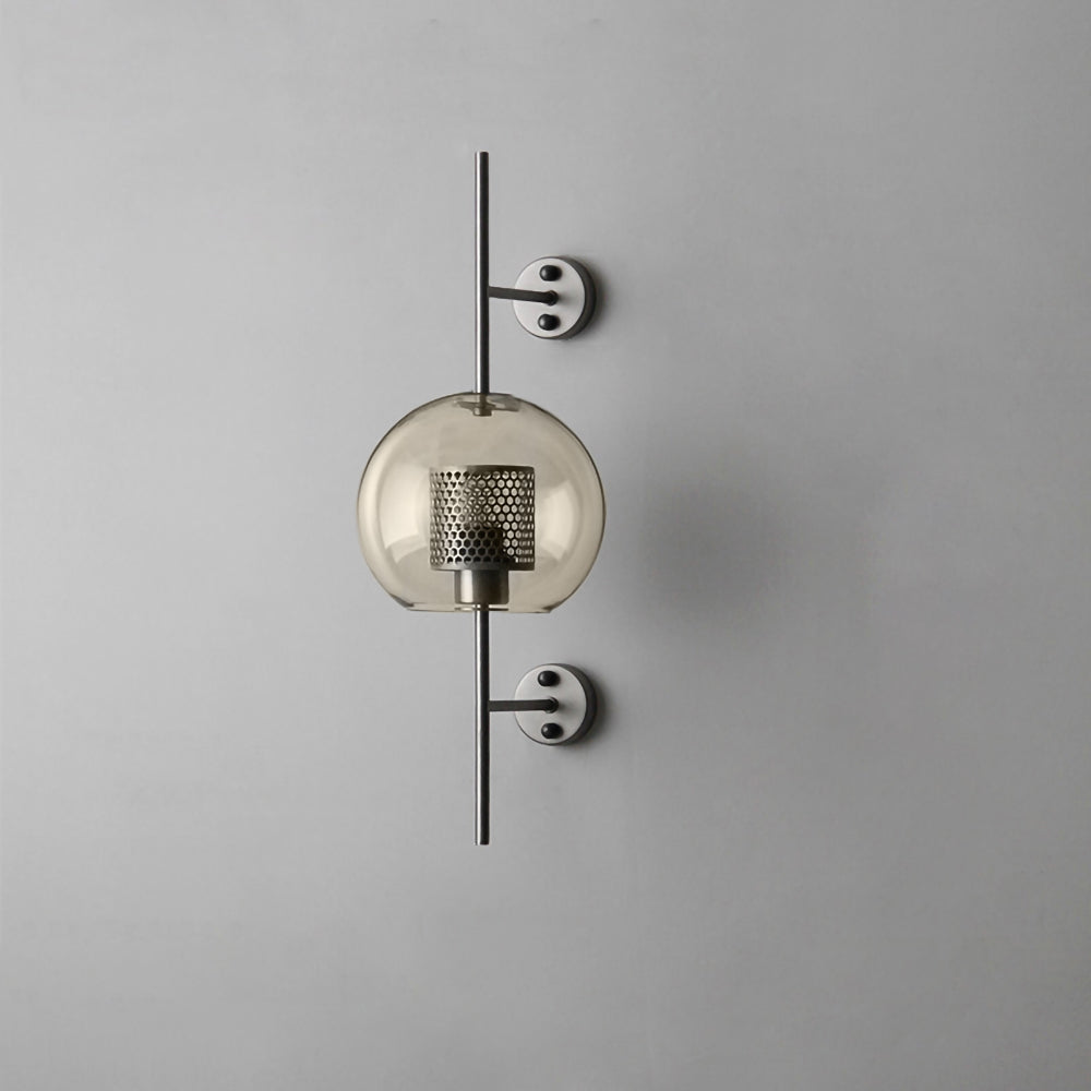 Glass wall light with metal stem casting soft light on a wall