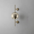 Glass globe wall light glowing warmly against a pale background