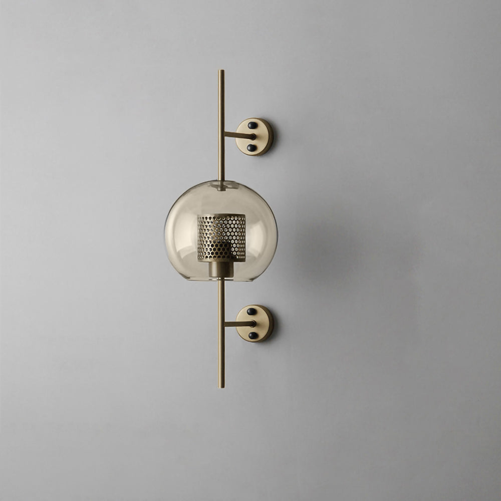 Glass globe wall light glowing warmly against a pale background