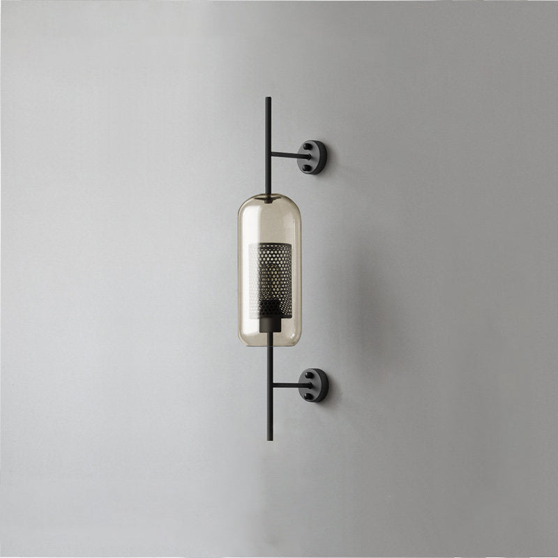 Glass wall light with warm glow mounted beside an interior wall