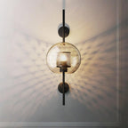 Glass wall light with warm glow mounted in a refined interior