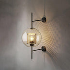 Capsule glass wall light in black finish with clear glass shade