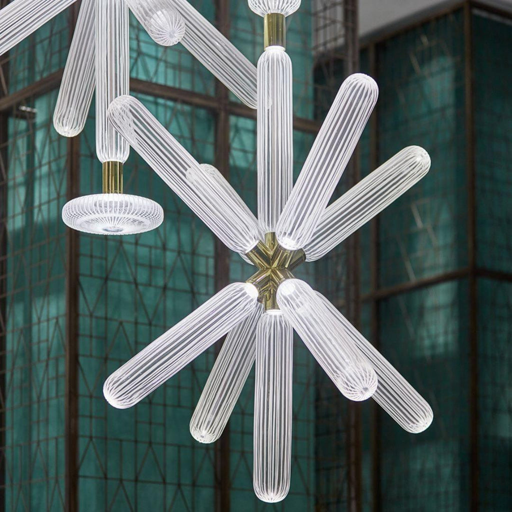 Close view of this Clérachic pendant's ribbed crystal rods against a jade-green glass screen.