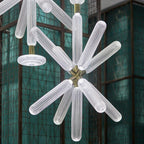 Close view of this Clérachic pendant's ribbed crystal rods against a jade-green glass screen.