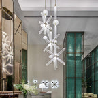Two Clérachic pendants at different heights glow beside green glass panels in a lobby setting.