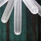 Close view of one ribbed crystal rod on this Clérachic pendant, lit from within.