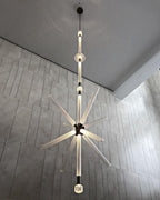 This Clérachic pendant drops from an angled ceiling, its crystal rods bursting low near the floor.