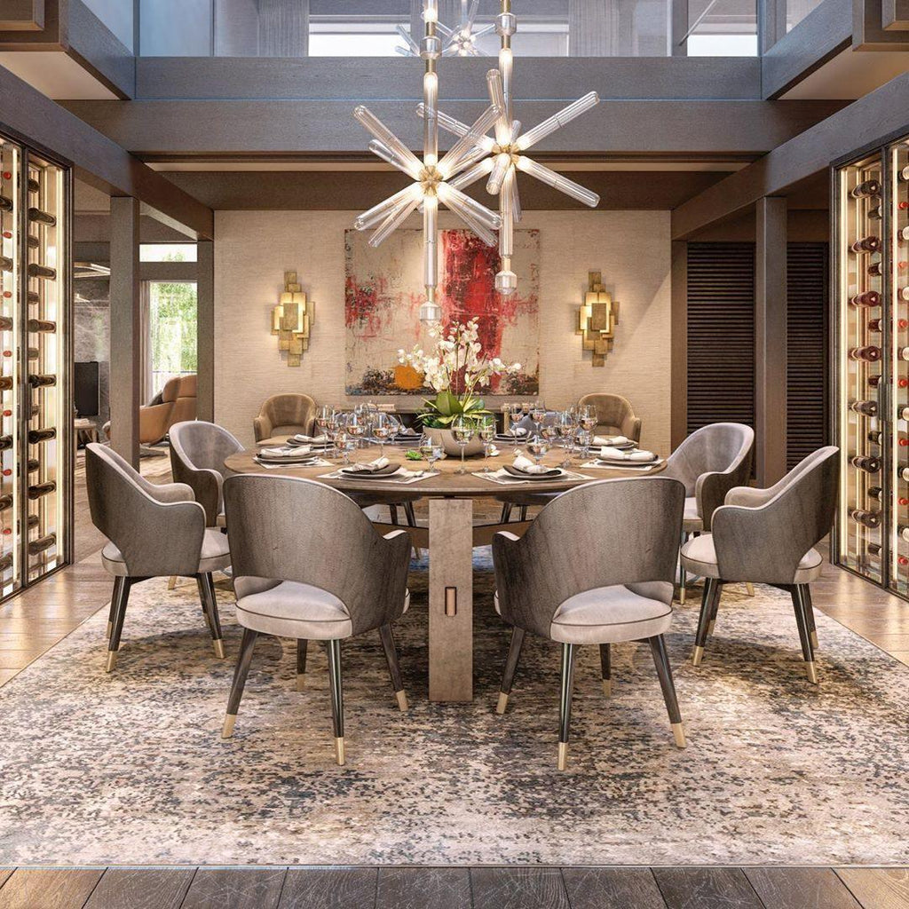 This Clérachic pendant lights a round dining table set for a meal in a warm dining room.