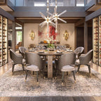 This Clérachic pendant lights a round dining table set for a meal in a warm dining room.