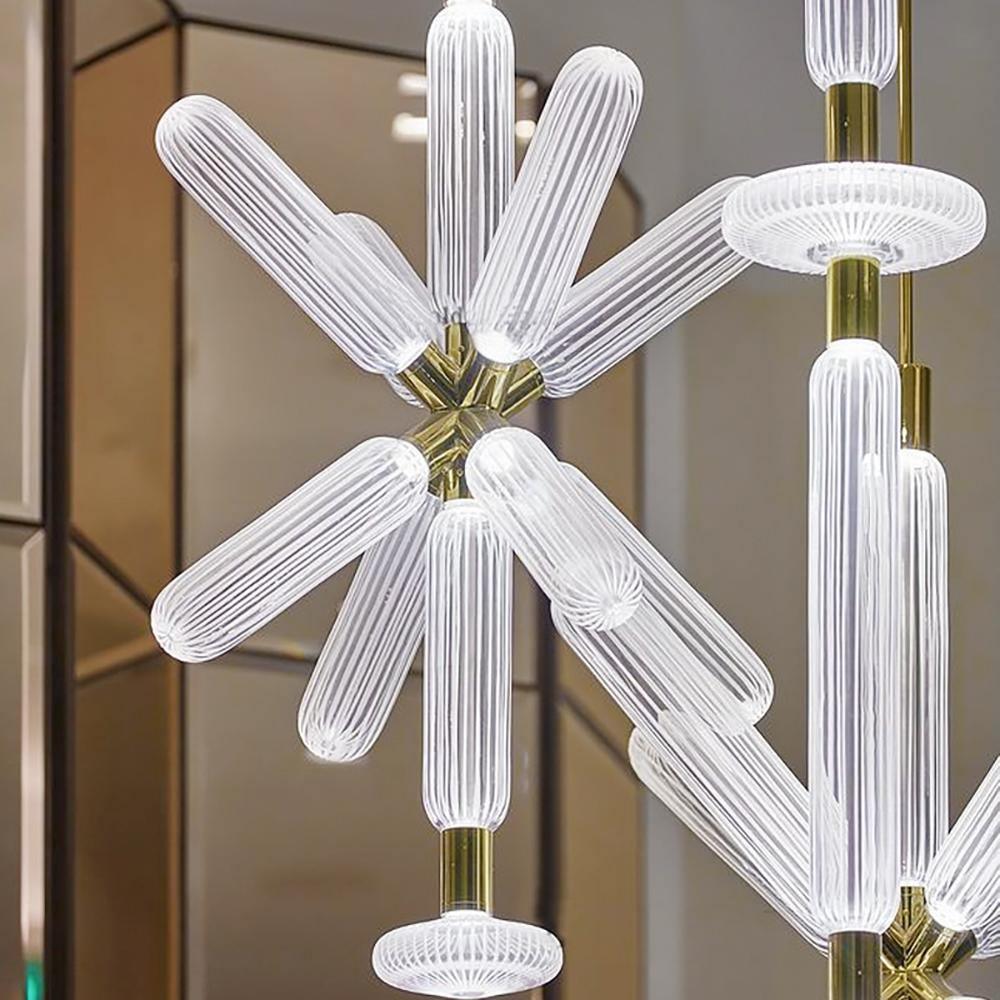 Close view of this Clérachic pendant's ribbed crystal rods meeting at a champagne-gold joint.