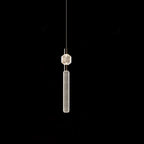 A faceted glass cap tops this Clérachic pendant's fluted cylinder, hung against black.