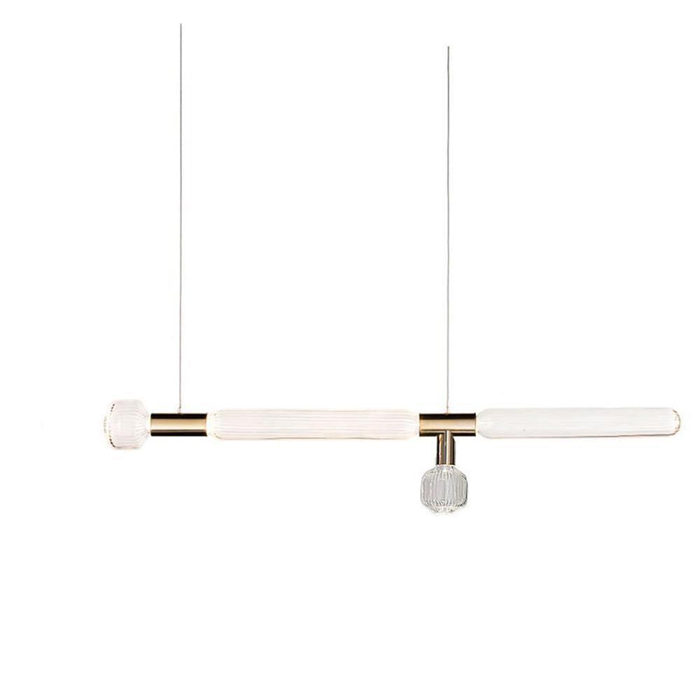 Two slim Clérachic pendants with fluted glass cylinders hang side by side on bare cords.
