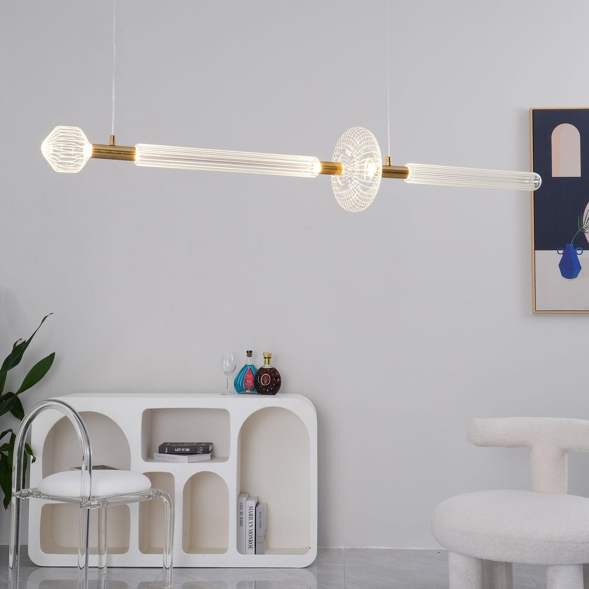 Above a curved console table, this Clérachic pendant's fluted rods glow warmly.
