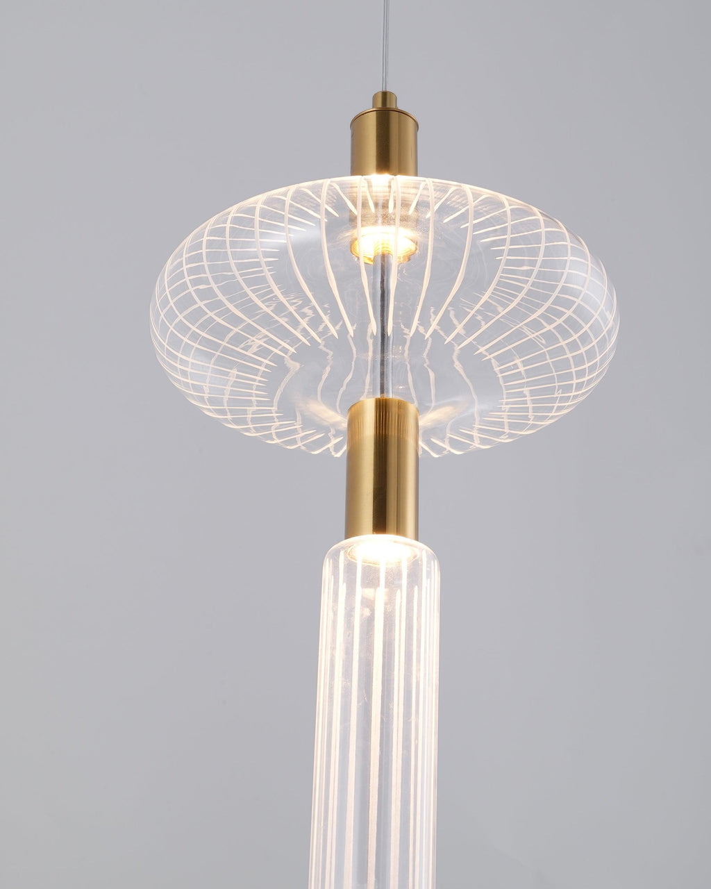 Close view of a lattice glass drum shade atop a ribbed rod on this Clérachic pendant.