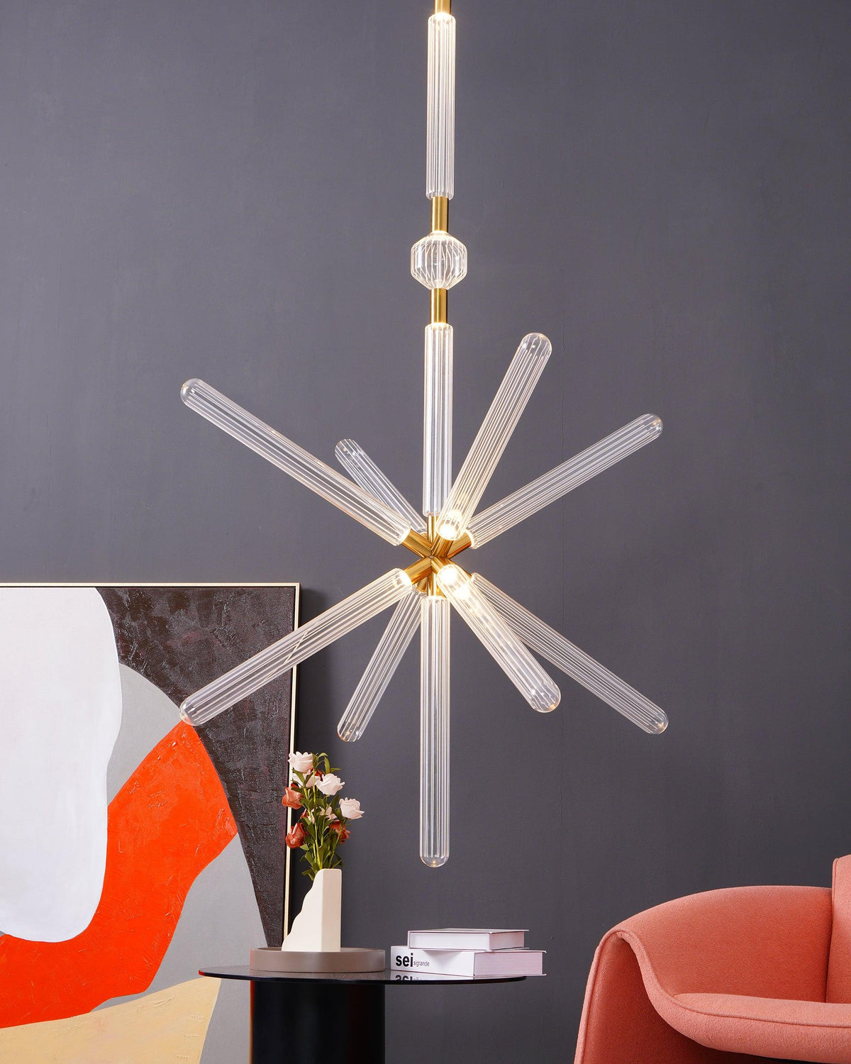This Clérachic pendant's crystal rods glow amber under warm light, in a room hung with bold abstract art.