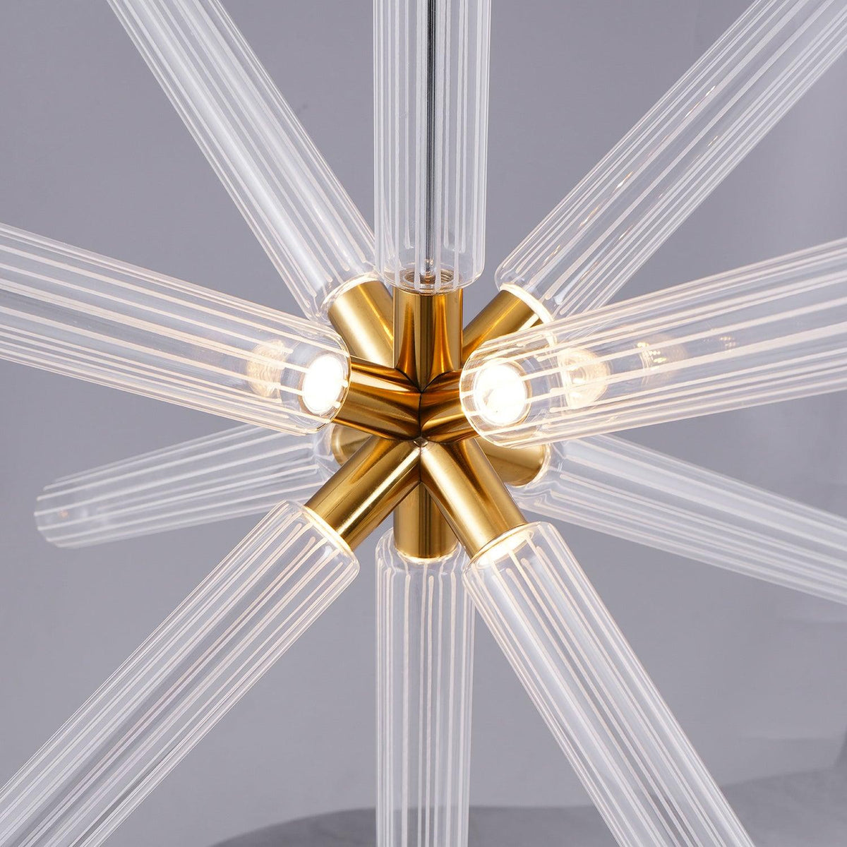 Close view of the gold centre where eight ribbed rods radiate on this Clérachic pendant.