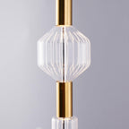 Close view of an angular ribbed glass shade on this Clérachic pendant's gold connector.