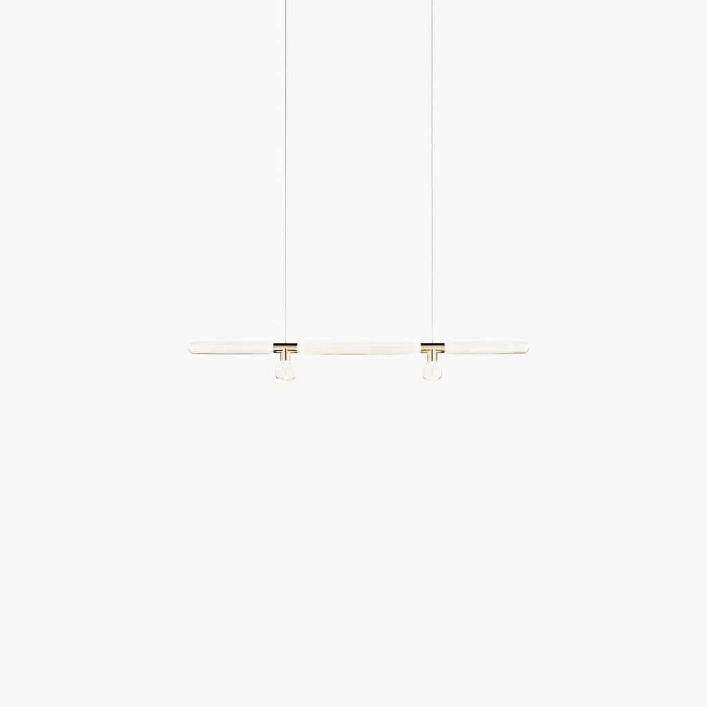 Faint and lit, this Clérachic pendant's slim bar glows softly on a white backdrop.