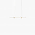 Faint and lit, this Clérachic pendant's slim bar glows softly on a white backdrop.