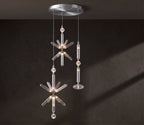 A crystal burst and a fluted rod, both Clérachic pendants, hang from a nickel ceiling plate.