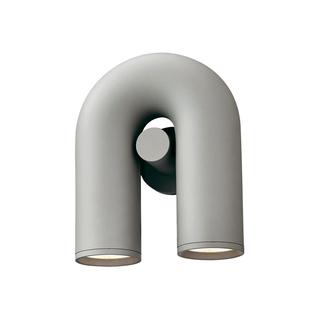 This grey Clérachic wall light stands unlit on a white backdrop, showing its U-shaped tube from the front.