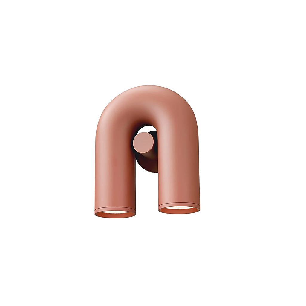 This terracotta Clérachic wall light sits small and centred, unlit, on a plain backdrop.