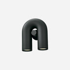 This black Clérachic wall light faces forward, unlit, on a plain light backdrop.