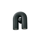 Three-quarter view of this black Clérachic wall light, unlit, against a plain backdrop.