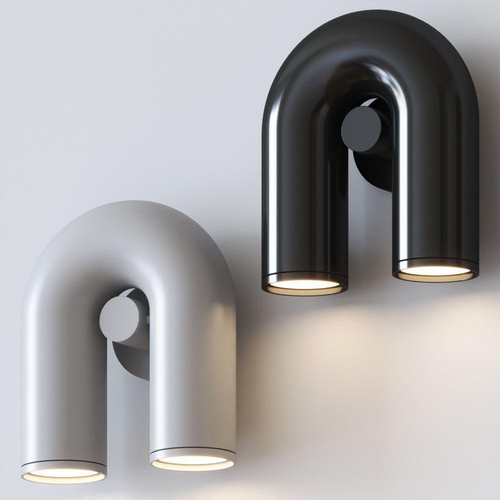 Side by side, a grey and a black Clérachic wall light both glow against a plain grey backdrop.