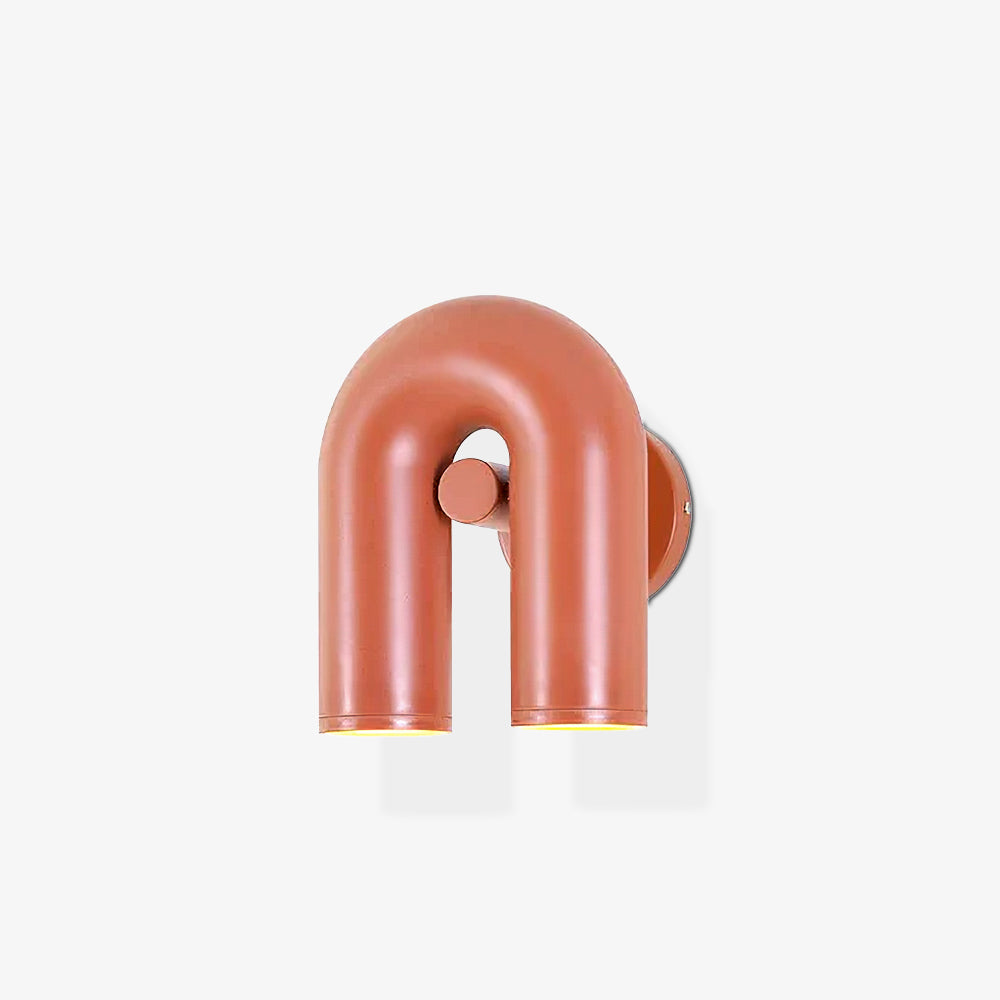 This terracotta Clérachic wall light stands small and unlit on a plain light backdrop.