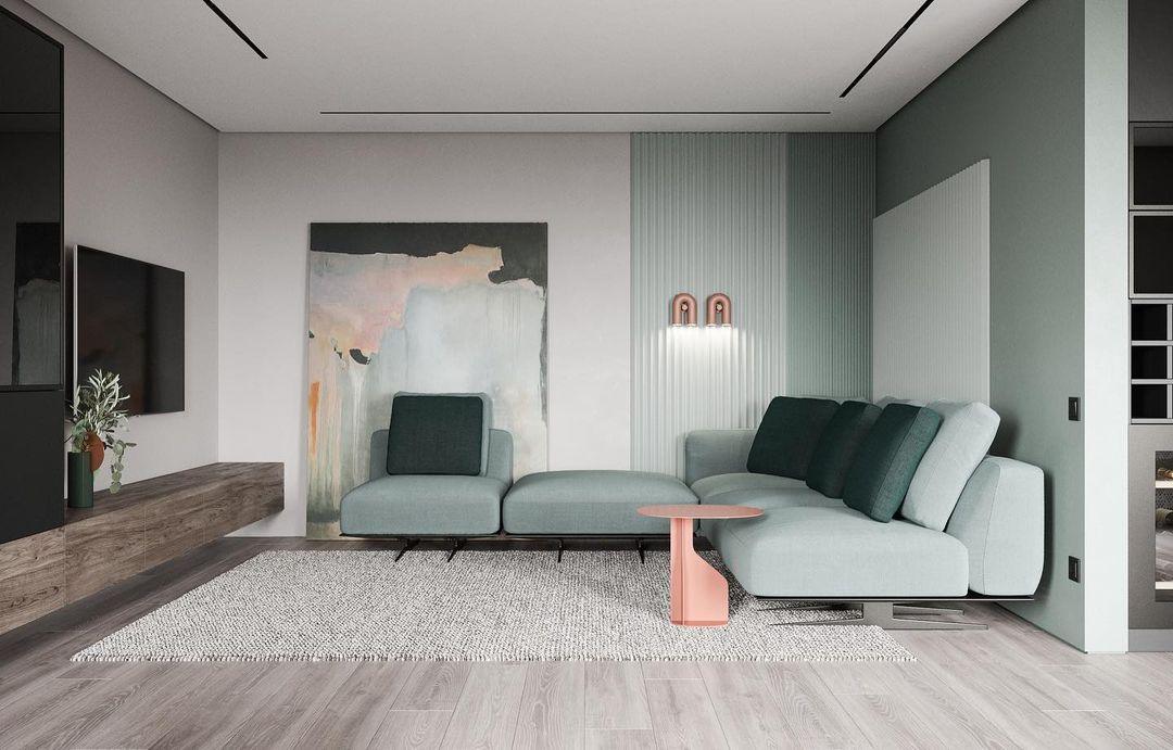Barely visible on a living room wall, a small terracotta Clérachic wall light sits near framed art above the sofa.
