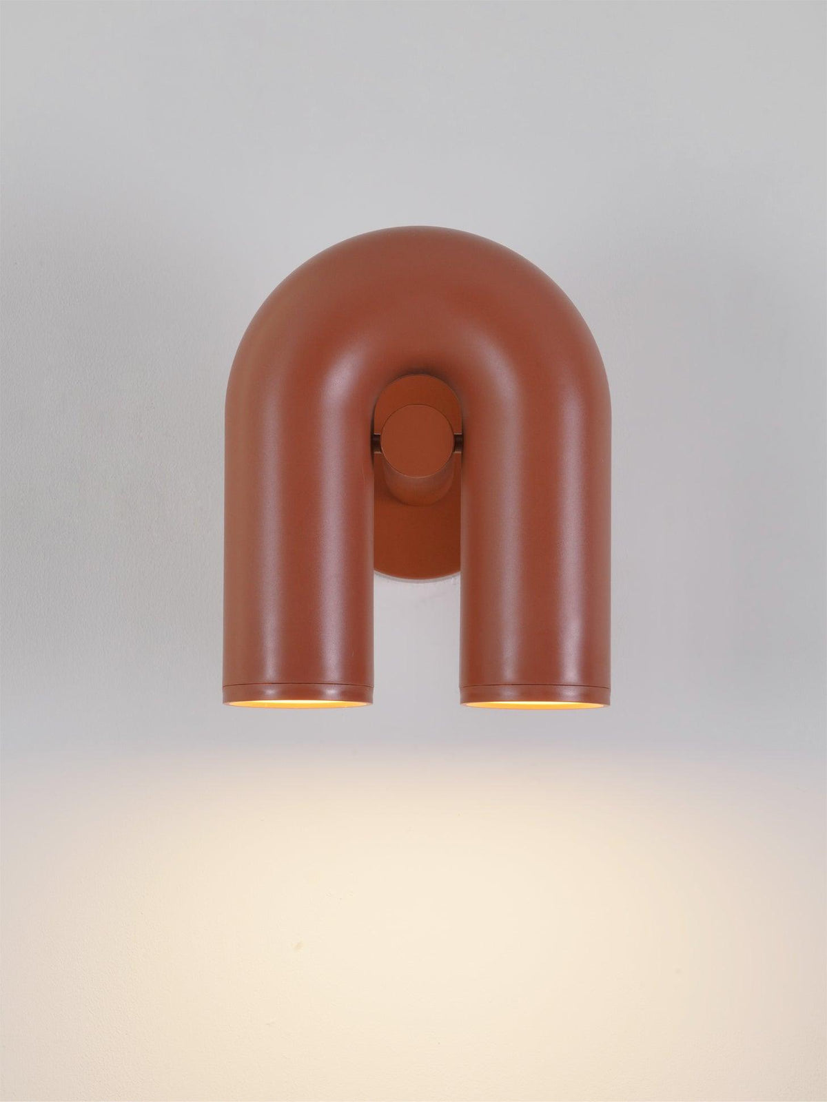 This Clérachic wall light in terracotta faces forward, unlit, against a plain light backdrop.