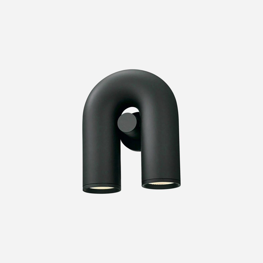 Full-length studio shot of this Clérachic wall light in black, unlit, against a plain light backdrop.