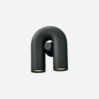 Full-length studio shot of this Clérachic wall light in black, unlit, against a plain light backdrop.