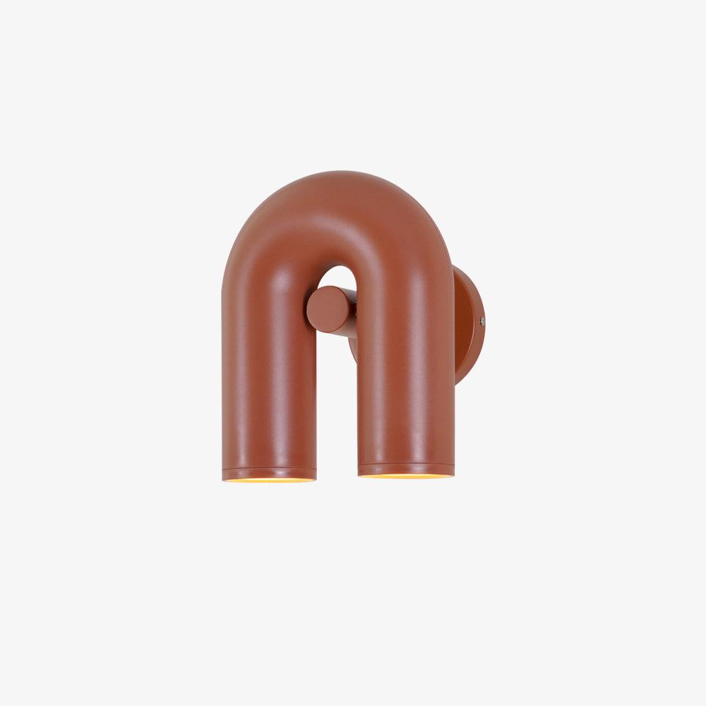 Angled view of this terracotta Clérachic wall light shows its round mounting plate, unlit.