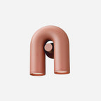 Compact front view of this terracotta Clérachic wall light, unlit, on a plain backdrop.