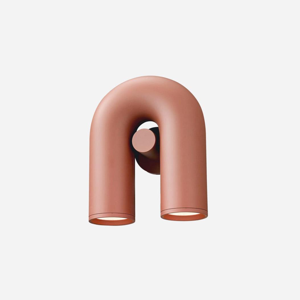 Compact front view of this terracotta Clérachic wall light, unlit, on a plain backdrop.
