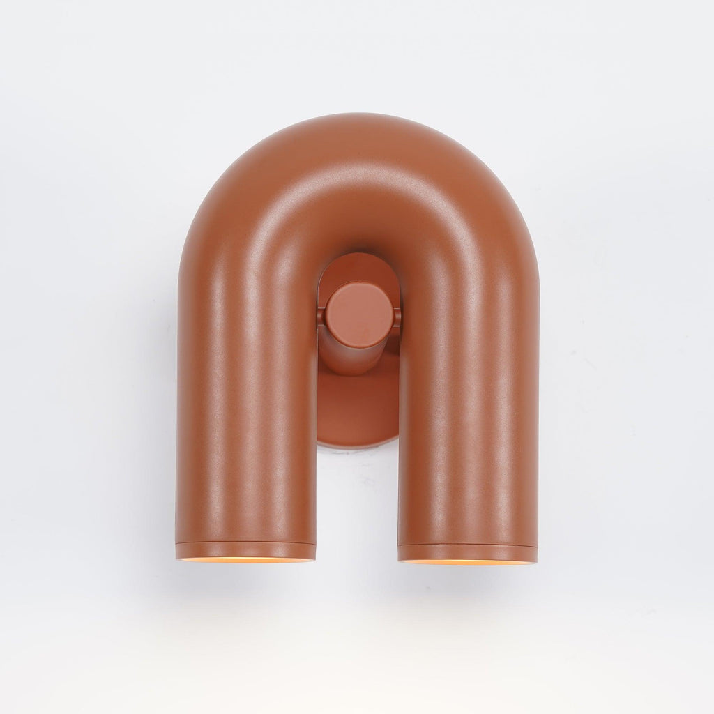 Large front view of this terracotta Clérachic wall light shows its full U-shaped tube, unlit.