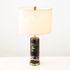 The Clérachic table lamp is shown on white with its brass neck ring visible just beneath the fabric shade.