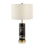 The Clérachic table lamp stands on a plain background, its unlit cream shade above the black marble base.
