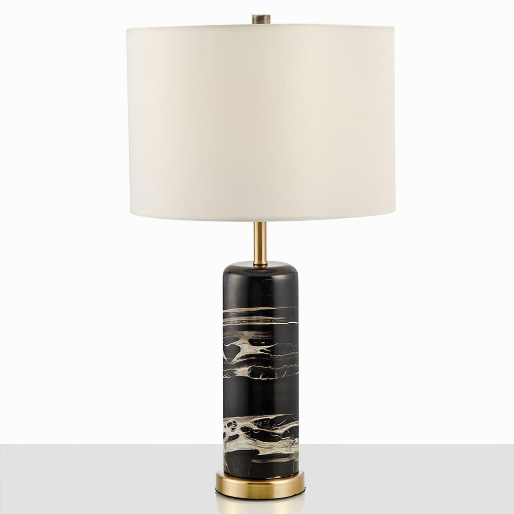 Another full studio view of the Clérachic table lamp on grey, its brass collar catching the light.