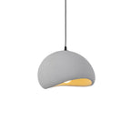 Soft cloud pendant light suspended over a seating area